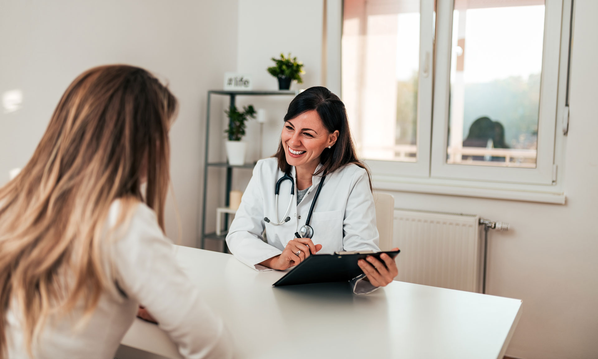 Beautiful Female Specialist Talking To Her Patient.